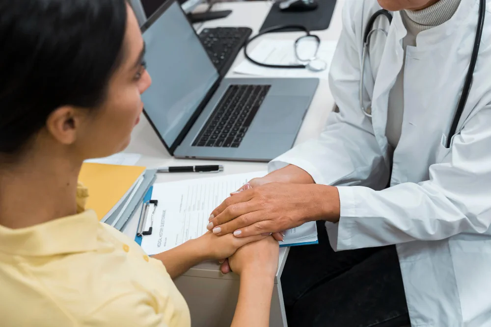 Healthcare professional providing reassuring support to a patient