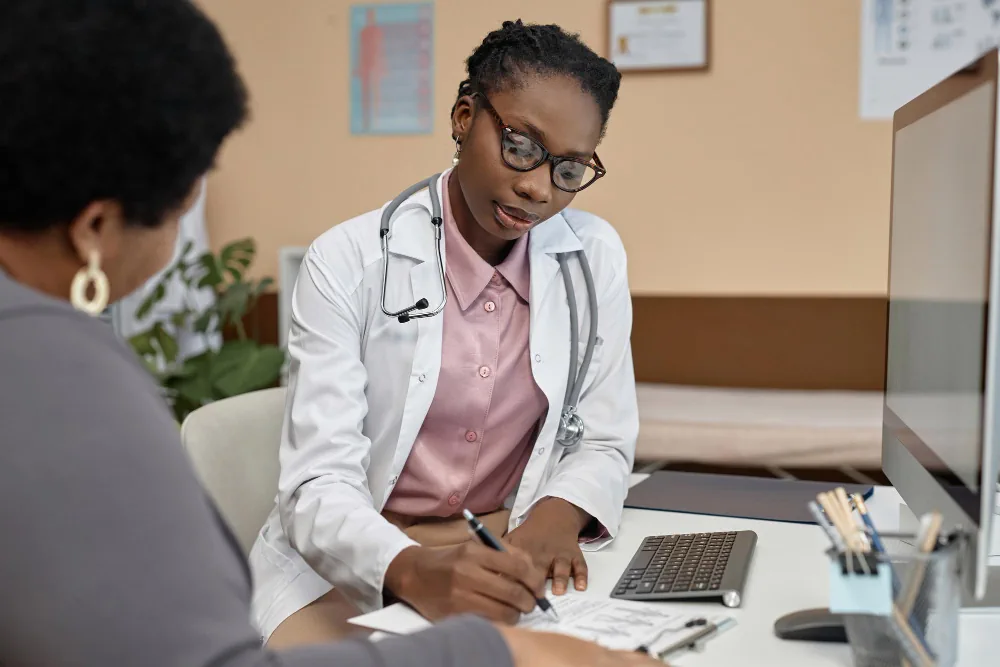 Healthcare provider discussing a patient's health during an annual examination