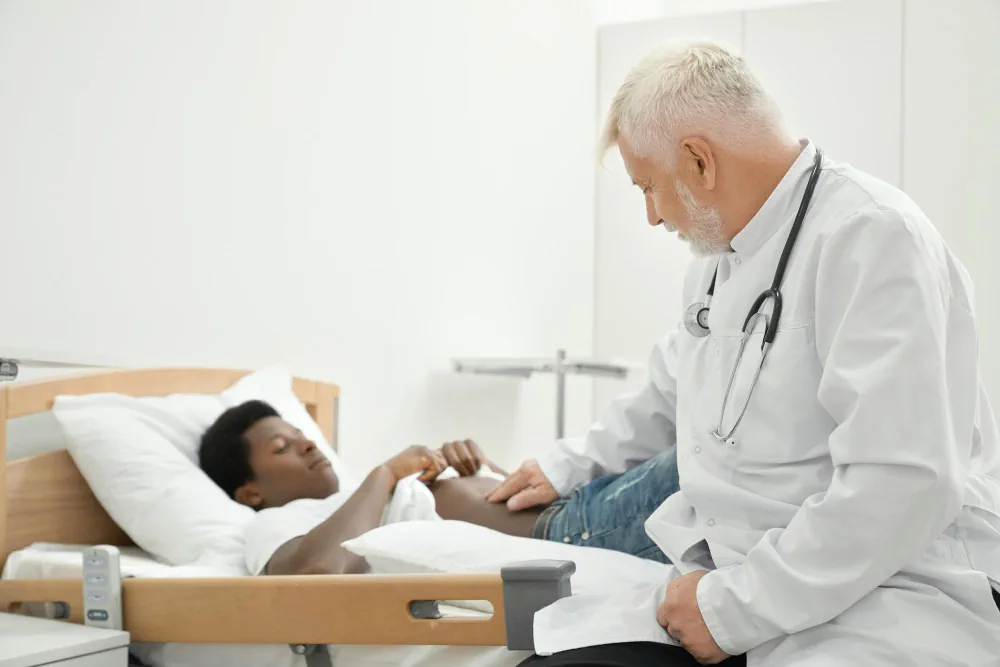 Healthcare provider checking on a patient at the bedside