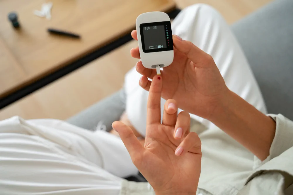 Blood glucose finger prick test being performed at home