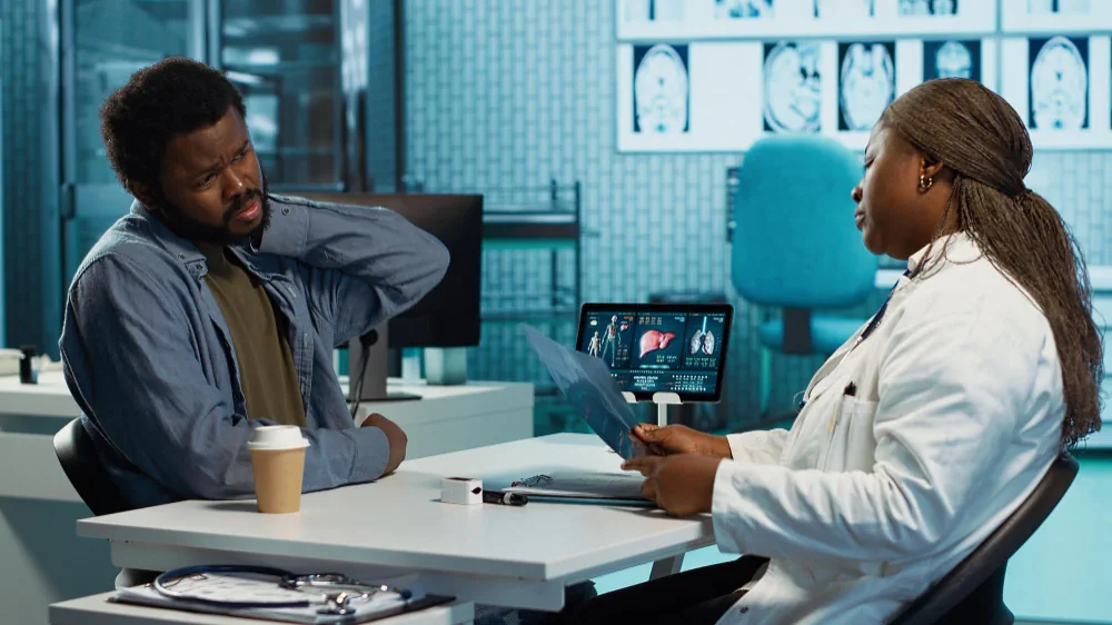 Healthcare provider speaking with a patient during an ongoing care consultation