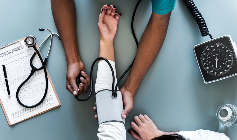 Healthcare provider checking blood pressure during a medical screening