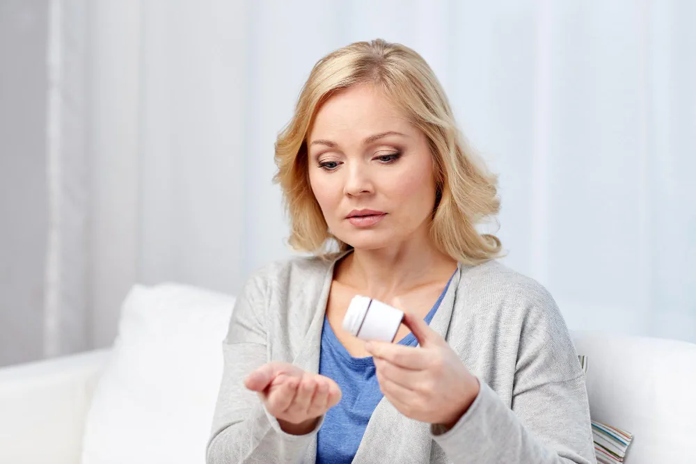 Woman reviewing medication while considering a hormone related health concern