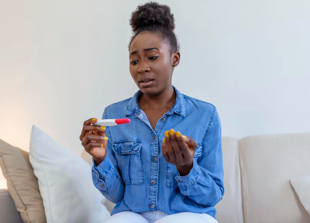 Woman holding medication at home while reviewing her healthcare needs