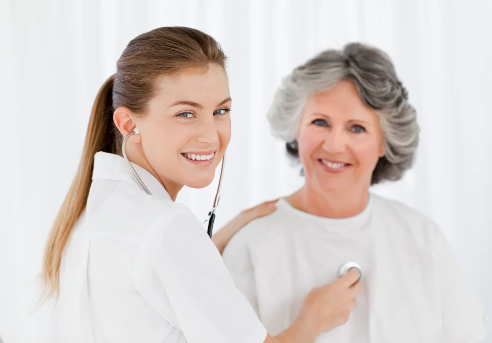 Younger and older women smiling together representing hormone health through different life stages