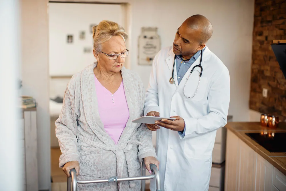 Healthcare provider assisting a patient during a home visit
