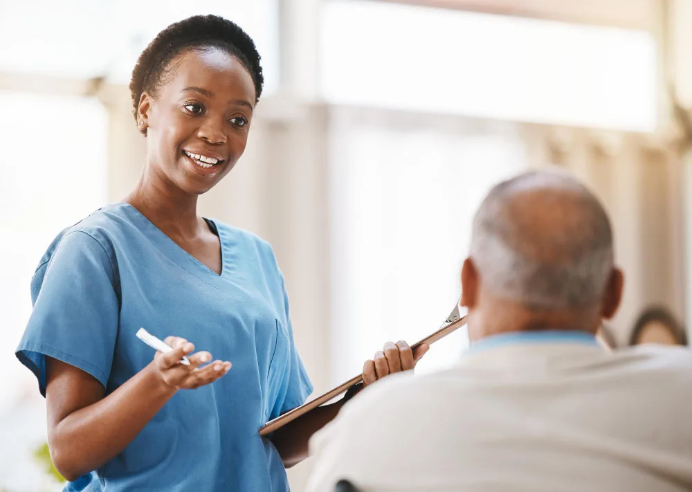 Healthcare professional speaking with an older adult about support needs