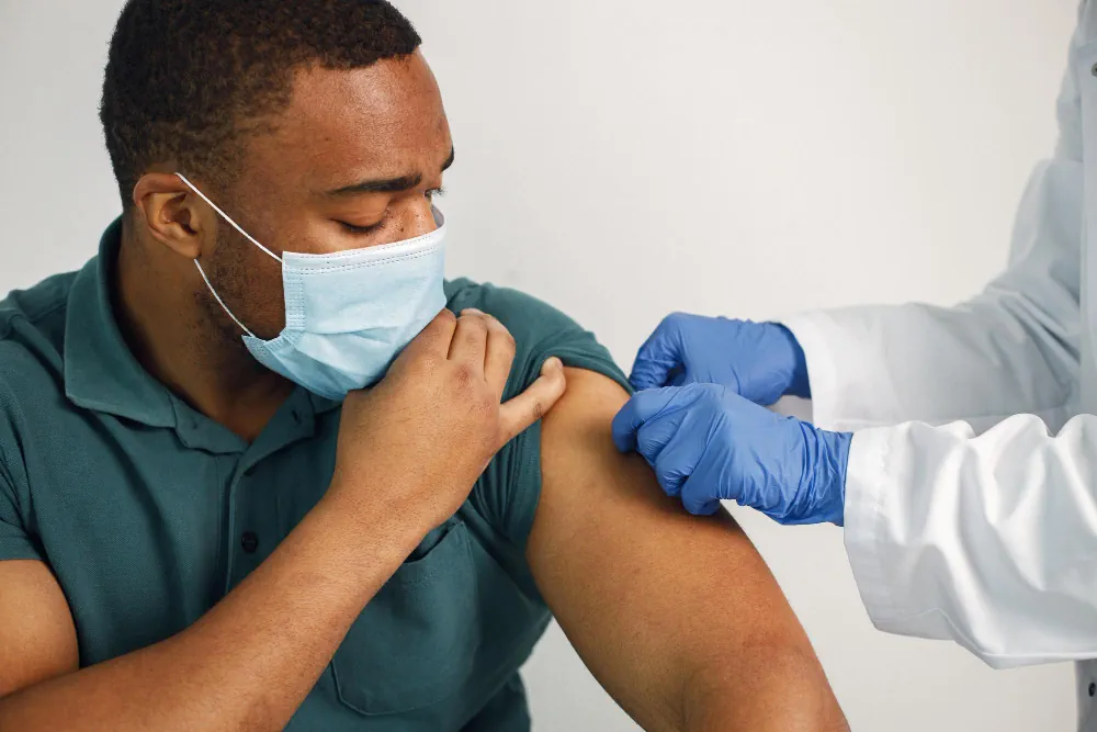 Patient receiving a vaccine injection from a healthcare provider