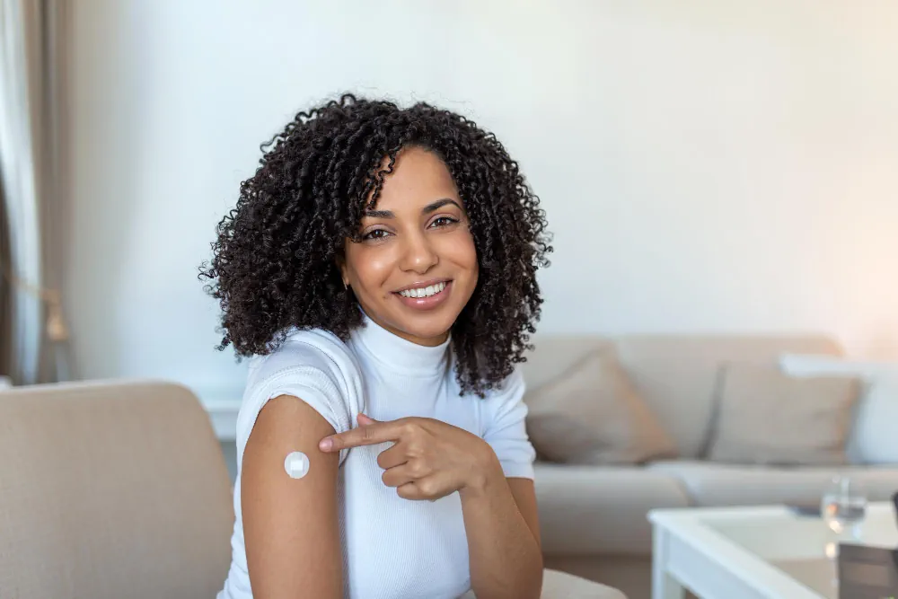 Patient showing her arm after receiving a vaccination
