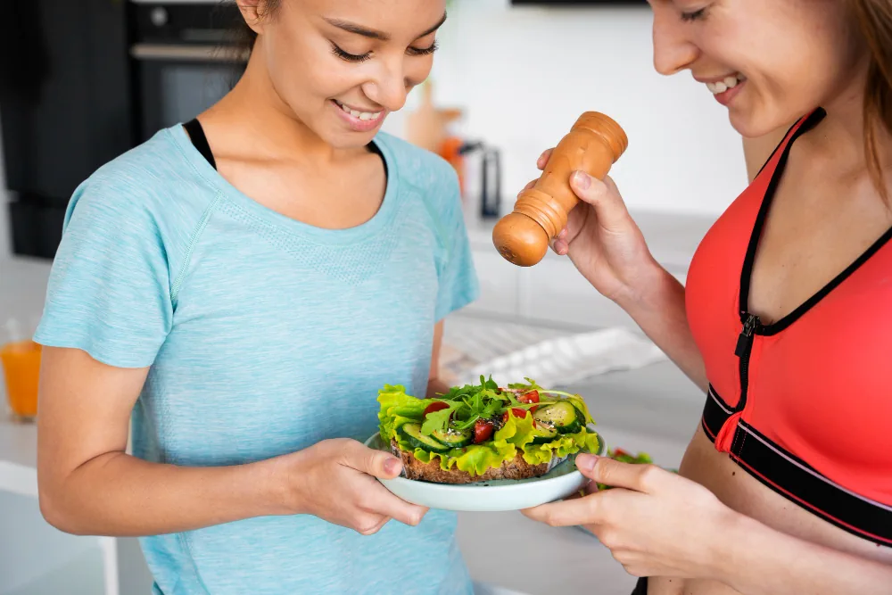Women preparing a healthy salad together