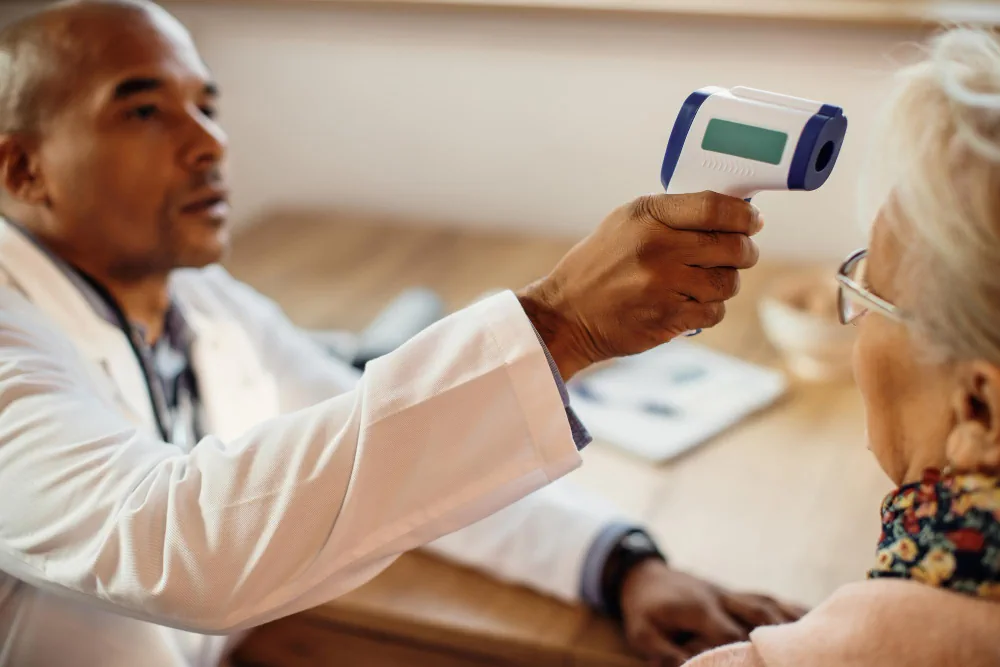 Healthcare provider checking a patient's temperature