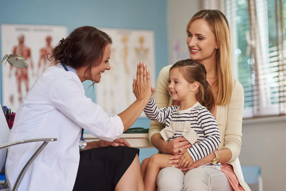 Healthcare provider meeting with a mother and child